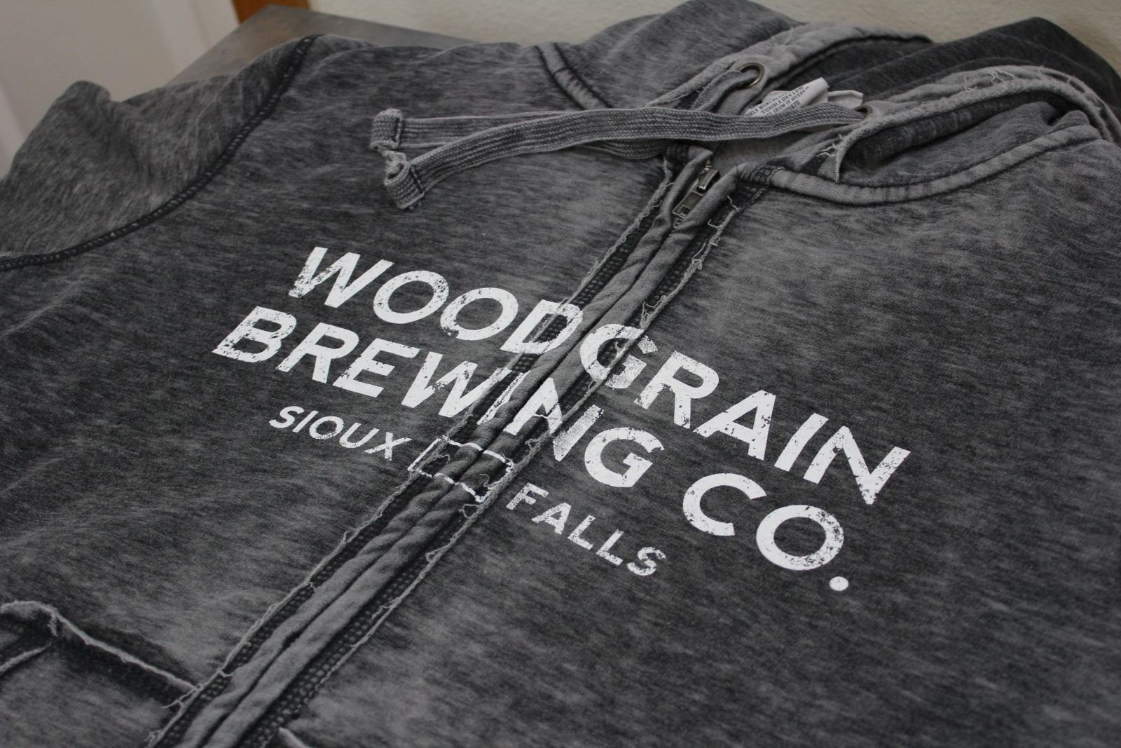 Woodgrain Brewing Co. acid-wash zip hoodie with tonal print