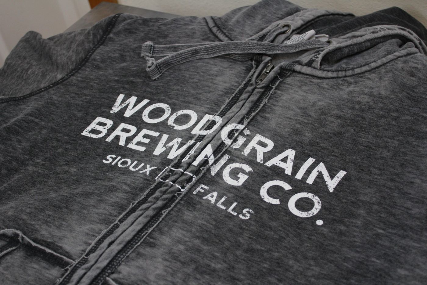 A local brand's logo, printed to hold up wash after wash. — custom apparel, Grocott Ink & Thread